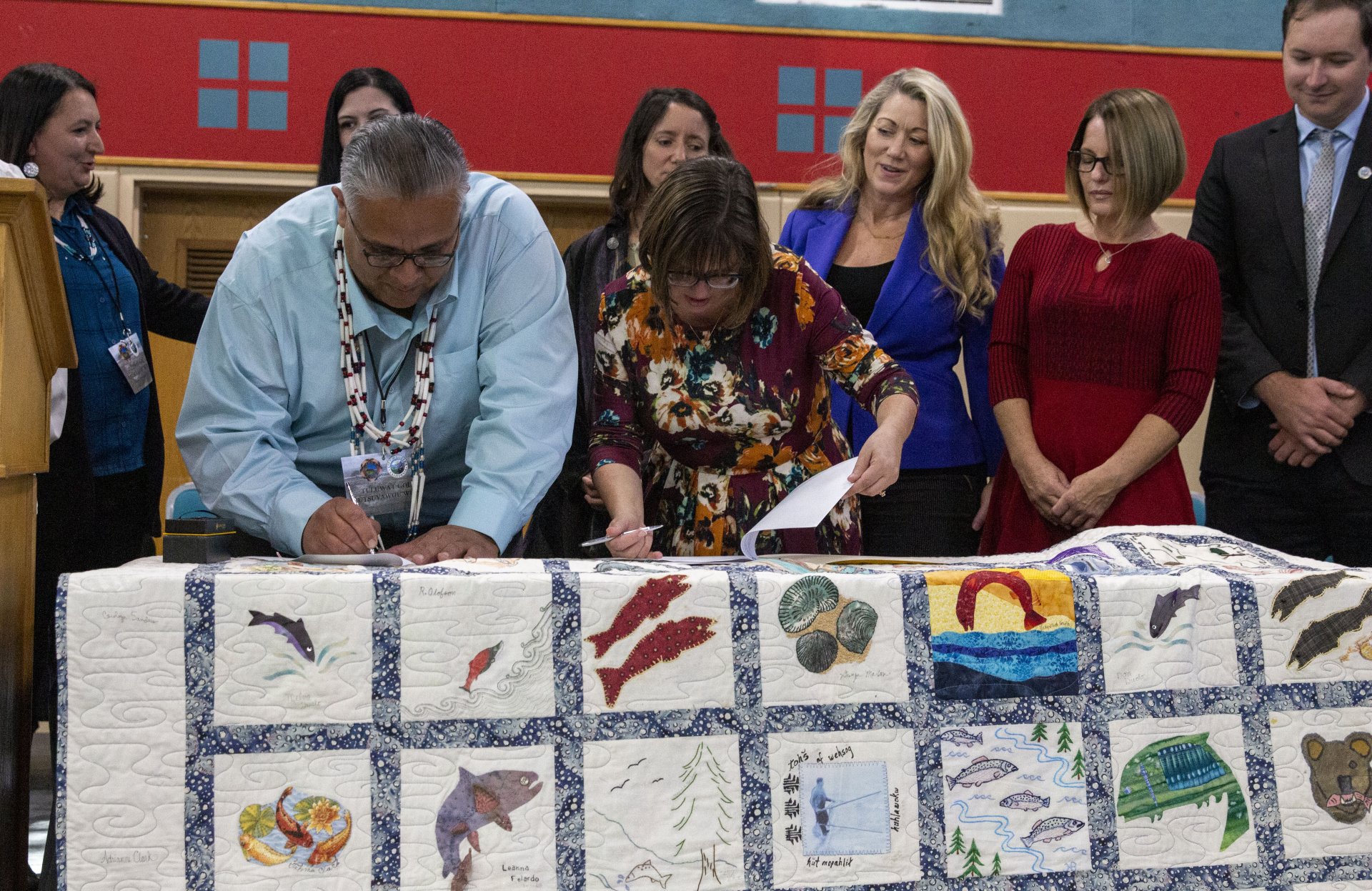Wiyot Tribal Chairman Ted Hernandez and Eureka Mayor Susan Seaman sign papers on Oct. 21 to officially return Tuluwat Island to the Wiyot Tribe at the Adorni Center. | Photo by Thomas Lal